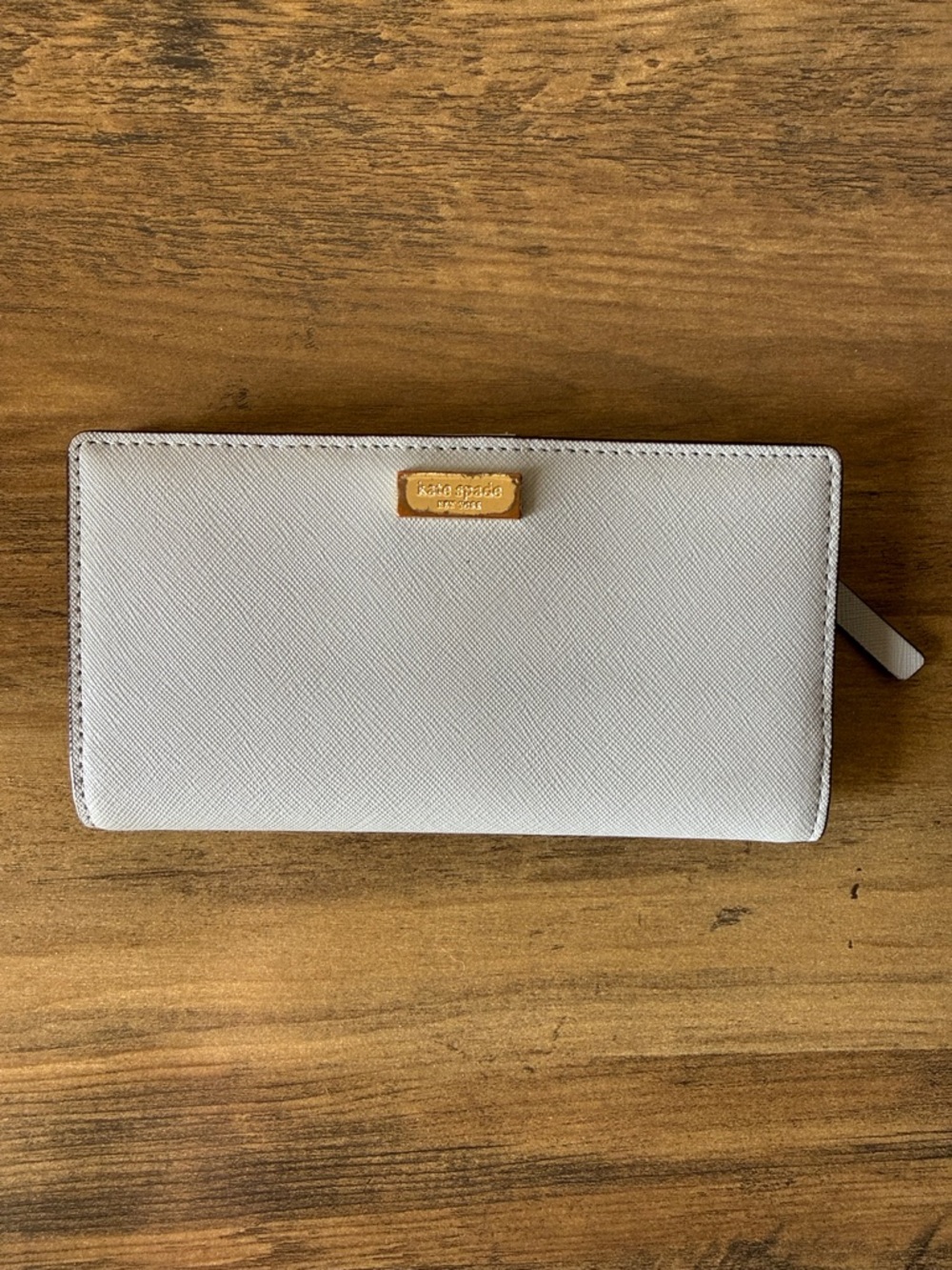 Kate Spade gray saffiano zip wallet with gold plaque